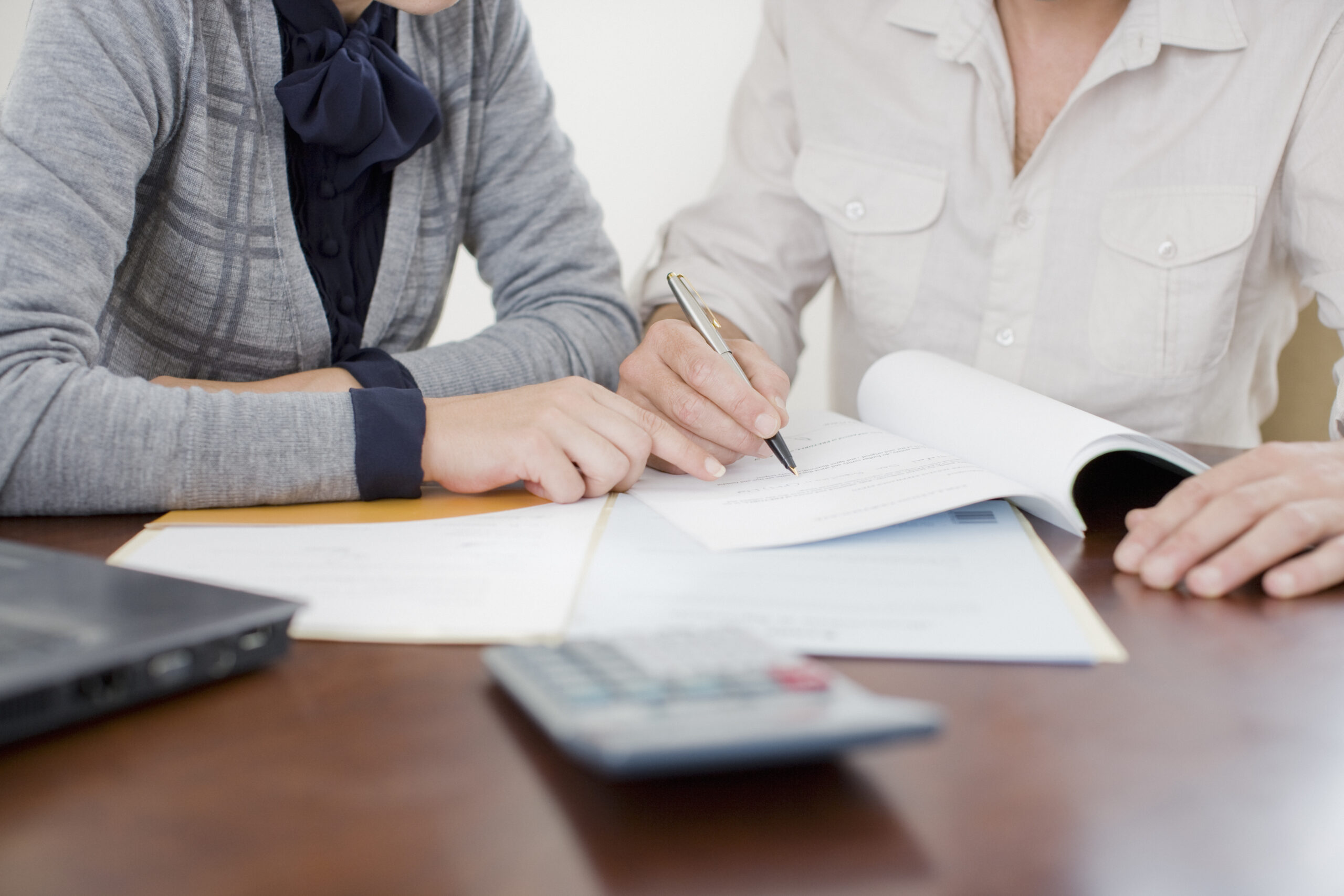 Businesswoman signing paperwork